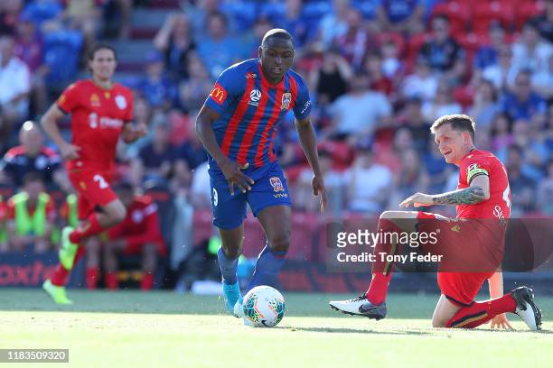 Abdiel Arroyo of the Newcastle Jets contests the ball with Michael Jakobsen of Adelaide United during the round three A-League match between the...