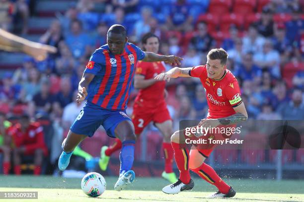 Abdiel Arroyo of the Newcastle Jets contests the ball with Michael Jakobsen of Adelaide United during the round three A-League match between the...