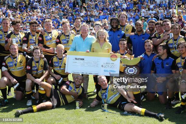 Andrew and Nicola Forrest pose with the Force after donating a cheque for $609,000 to Telethon following the NRC Final between the Western Force and...