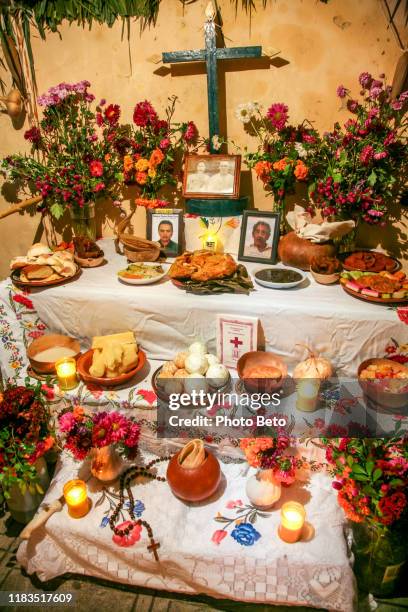 an altar with offerings to the deceased during traditional dia de muertos celebrations in yucatan in southern mexico - altare stock pictures, royalty-free photos & images