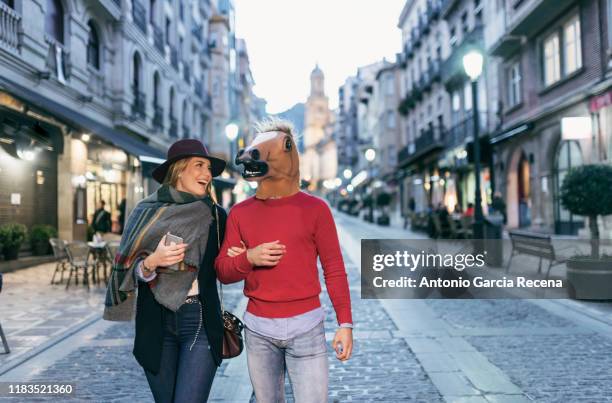 strange couple in european city, men with mask - jaén city stock pictures, royalty-free photos & images