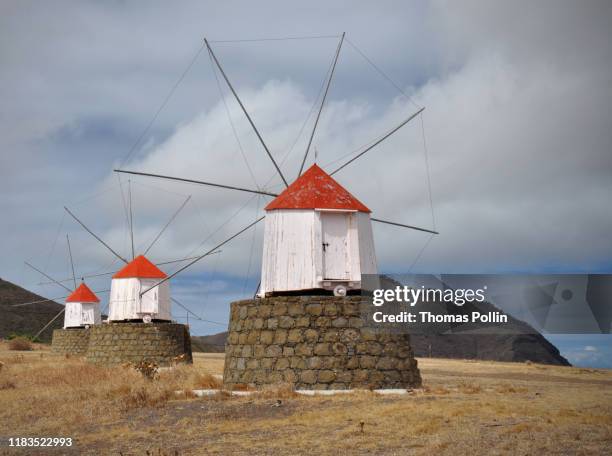 windmills on porto santo island - madeira material stock-fotos und bilder