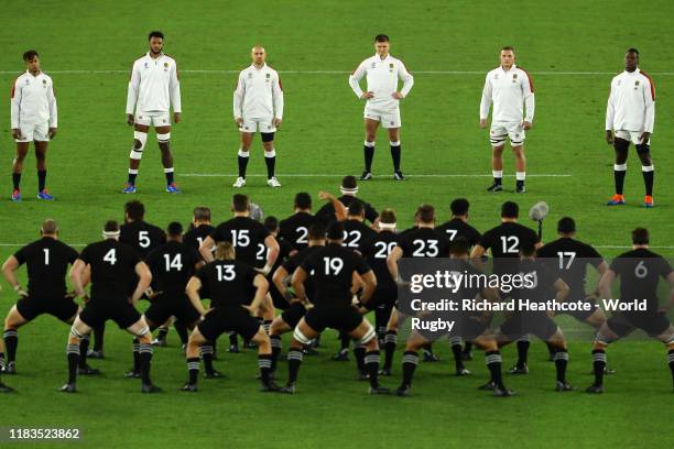 England players look on while New Zealand players perform a haka during the Rugby World Cup 2019 Semi-Final match between England and New Zealand at...