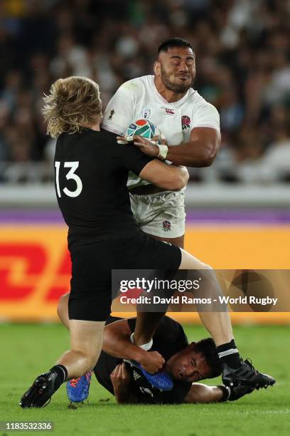 Manu Tuilagi of England is tackled by Jack Goodhue and Anton Lienert-Brown of New Zealand during the Rugby World Cup 2019 Semi-Final match between...