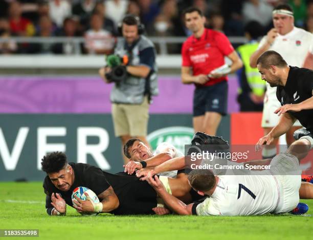 Ardie Savea of New Zealand scores a try in the tackle of Sam Underhill of England during the Rugby World Cup 2019 Semi-Final match between England...