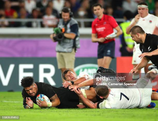 Ardie Savea of New Zealand scores a try in the tackle of Ben Youngs and Sam Underhill of England during the Rugby World Cup 2019 Semi-Final match...