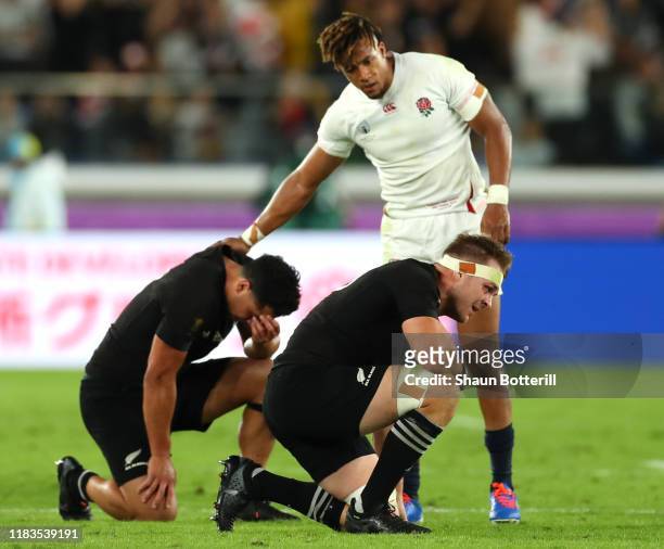 Anthony Watson of England consoles Anton Lienert-Brown of New Zealand while Sam Cane shows his disappointment after the final whistle during the...