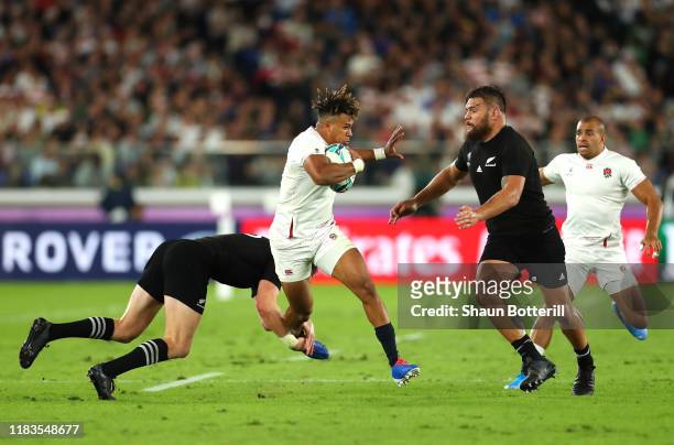Anthony Watson of England breaks past Jordie Barrett and Angus Ta'Avao of New Zealand during the Rugby World Cup 2019 Semi-Final match between...