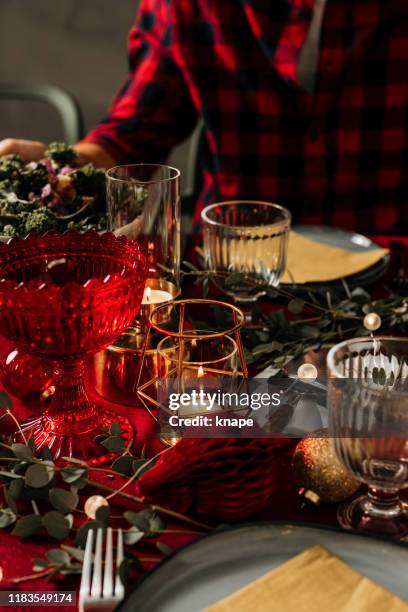 man sitting by set christmas table - christmas scandinavia stock pictures, royalty-free photos & images