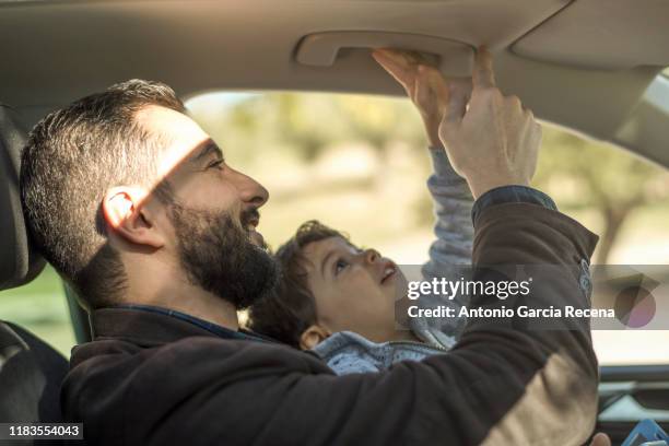 father and son playing in car suv - lift roof bildbanksfoton och bilder