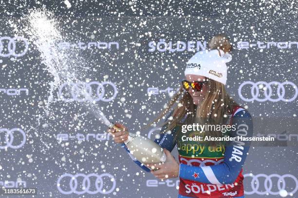 Alice Robinson of New Zealand celebrates winning the Audi FIS Alpine Ski World Cup - Women's Giant Slalom during the flower ceremony for the Audi FIS...