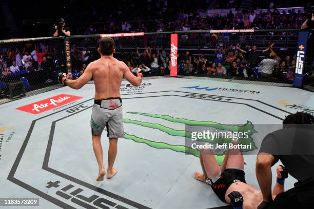 Demian Maia of Brazil celebrates his submission victory over Ben Askren in their welterweight bout during the UFC Fight Night event at Singapore...