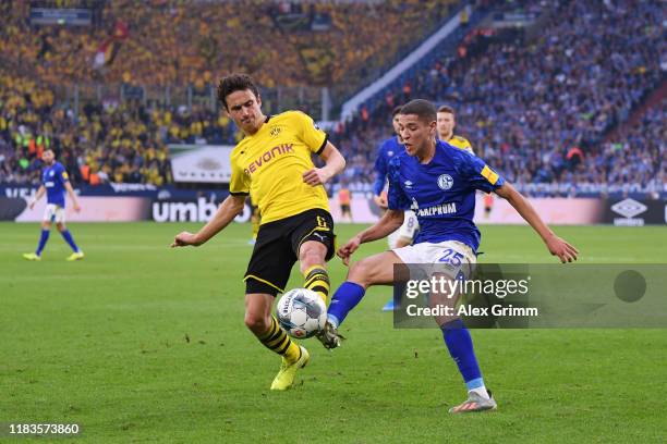 Thomas Delaney of Borussia Dortmund battles for possession with Amine Harit of FC Schalke 04 during the Bundesliga match between FC Schalke 04 and...