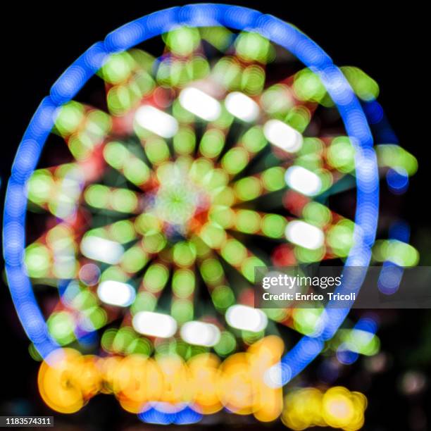 soft-focus of a carousel on moving, with a lot of little lights and colours during the night - softfocus stock pictures, royalty-free photos & images