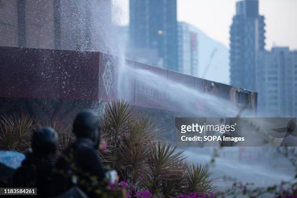 Water splash on the Logo of Polytechnic University of Hong Kong during the demonstration. Police surround the Polytechnic University after...