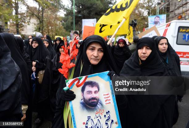 People attend a funeral ceremony of 2 security officers, who lost their lives in petrol price hike protests, in Tehran, Iran on November 20, 2019....