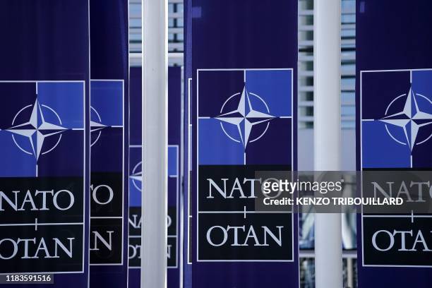 Picture taken on November 20, 2019 shows NATO flags at the NATO headquarters in Brussels, during a NATO Foreign Affairs ministers' summit. - NATO...