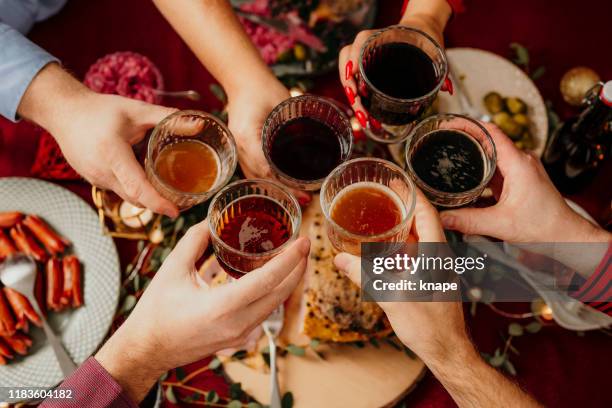 christmas food smorgasbord people toasting dinner party - party food and drink stock pictures, royalty-free photos & images
