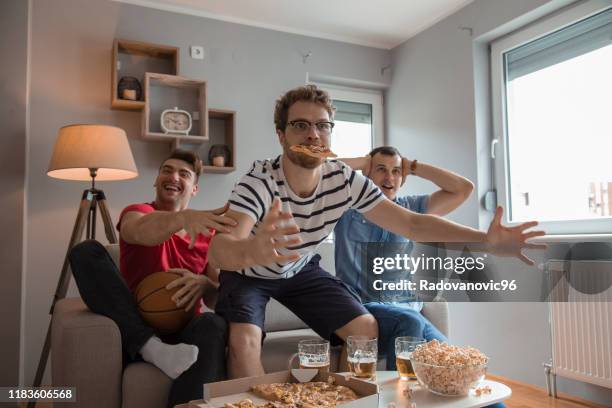 group of friends watching basketball game and drinking beer - home game sport stock pictures, royalty-free photos & images