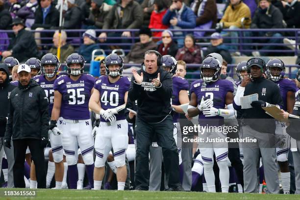 Head coach Pat Fitzgerald of the Northwestern Wildcats cheers on his team in the game against the Iowa Hawkeyes during the second quarter at Ryan...