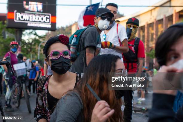 Anti-government demonstrator build a barricade on a street in Santiago during a protest against policies of president Sabastian Pinera. Santiago,...