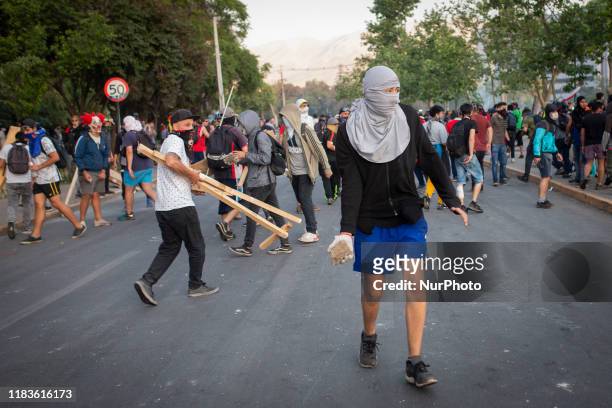 Anti-government protesters clash with police in Santiago, Chile, october 30, 2019.