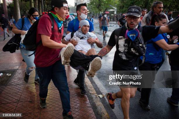 An injured man is attended to during a protest against Chile's government in Santiago, Chile October 30, 2019.