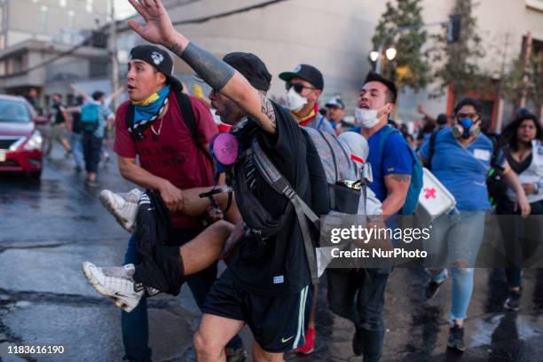 An injured man is attended to during a protest against Chile's government in Santiago, Chile October 30, 2019.