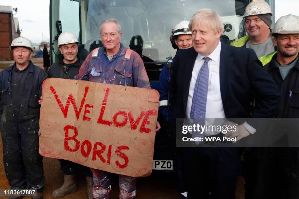 Prime Minister Boris Johnson poses with workers as he is given a tour during a visit to Wilton Engineering Services as part of a General Election...