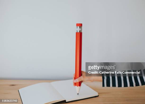 hand with a pencil - pencil with rubber stock pictures, royalty-free photos & images