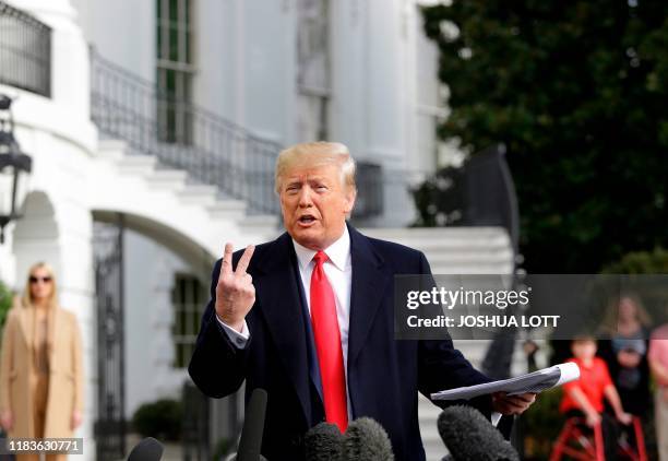 President Donald Trump reads from his notes as he talks to the media on the South Lawn of the White House before boarding Marine One in Washington,...