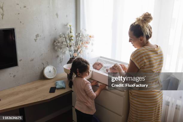 little girl jealous of her little baby girl - sibling jealousy stock pictures, royalty-free photos & images