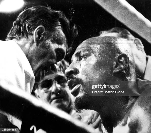 Marvelous Marvin Hagler, right, gets some ringside advice from trainer/manager Goody Petronelli, left, with co-manager Pat Petronelli in background,...