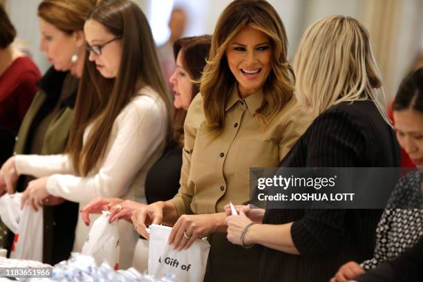 Second Lady Karen Pence and First Lady Melania Trump gather material during a Red Cross event to assemble comfort kits for troops deployed overseas,...