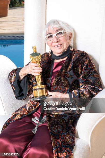 Lina Wertmuller poses with the Oscar of Dino de Laurentiis at the Honorary Oscar Lina Wertmuller's Celebration Lunch Hosted By Martha De Laurentiis...