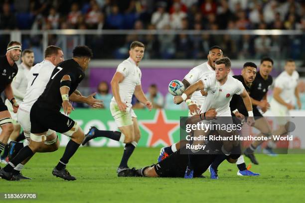 George Ford of England off loads the ball to Sam Underhill during the Rugby World Cup 2019 Semi-Final match between England and New Zealand at...