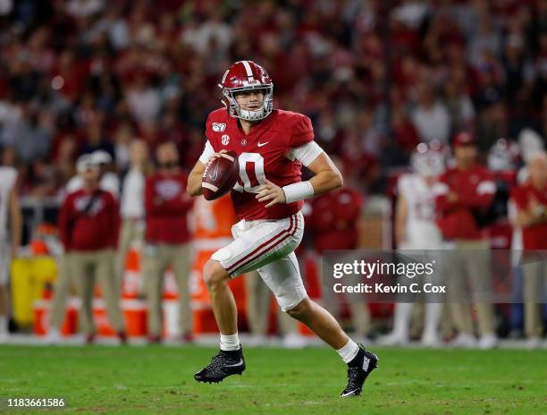 Mac Jones of the Alabama Crimson Tide rolls out of the pocket against the Arkansas Razorbacks in the first half at Bryant-Denny Stadium on October...