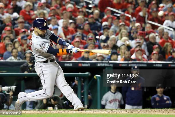 Robinson Chirinos of the Houston Astros hits a two-run home run against the Washington Nationals during the fourth inning in Game Four of the 2019...