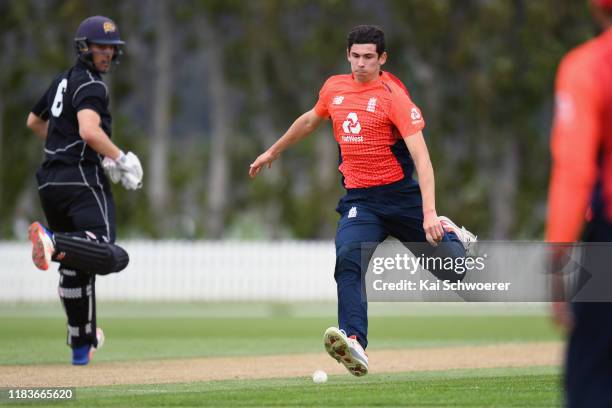 Pat Brown of England fields the ball off his own bowling during the Twenty20 International Tour match between the New Zealand XI and England on...