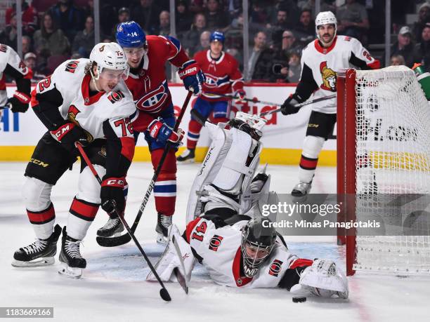 Goaltender Craig Anderson of the Ottawa Senators dives for the puck while teammate Thomas Chabot defends against the Montreal Canadiens during the...