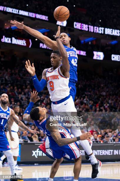 Barrett of the New York Knicks charges into Trey Burke of the Philadelphia 76ers in the fourth quarter at the Wells Fargo Center on November 20, 2019...