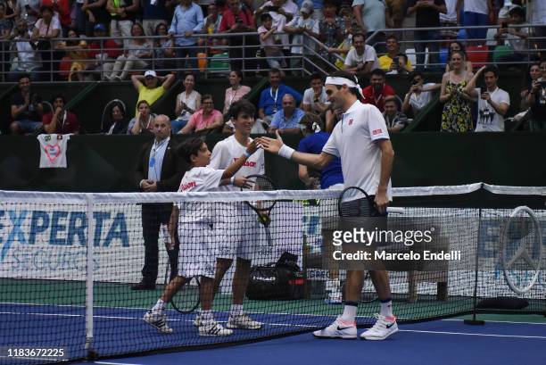 Roger Federer of Switzerland plays with ball boys during an exhibition game between Alexander Zverev and Roger Federer at Arena Parque Roca on...