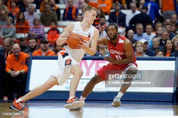 Syracuse Orange Guard Buddy Boeheim drives the ball against Cornell Big Red Guard Terrance McBride defending during the first half of the college...