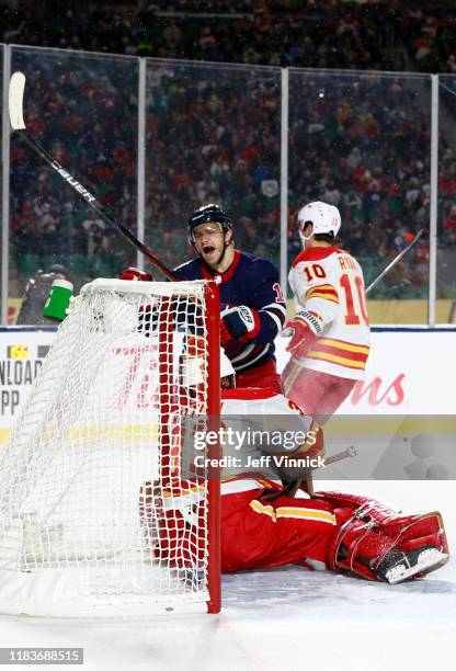 Bryan Little of the Winnipeg Jets reacts after scoring the game-winning goal against goaltender David Rittich of the Calgary Flames in overtime...