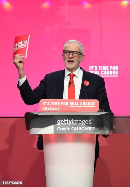Britain's opposition Labour Party leader Jeremy Corbyn holds aloft a copy of the party's manifesto, as he speaks during the launch of the Labour...