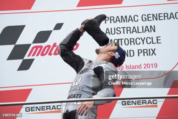 Jack Miller of Australia and Pramac Racing drinks from booth and celebrates on the podium after the 2019 MotoGP of Australia at Phillip Island Grand...