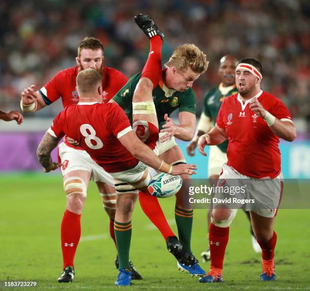 Ross Moriarty of Wales is tackled by Pieter-Steph du Toit of South Africa during the Rugby World Cup 2019 Semi-Final match between Wales and South...