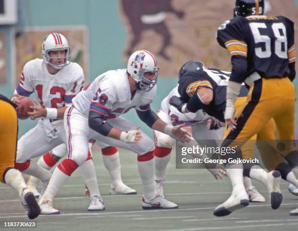 Center Pete Brock of the New England Patriots blocks as quarterback Matt Cavanaugh looks to pass against the Pittsburgh Steelers during a game at...