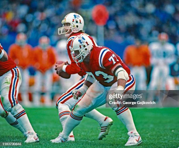 Offensive lineman John Hannah of the New England Patriots blocks as quarterback Tony Eason drops back to pass during a game against the Cleveland...