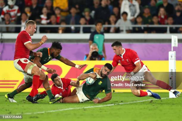 Damian de Allende of South Africa goes over to score his team's first try during the Rugby World Cup 2019 Semi-Final match between Wales and South...